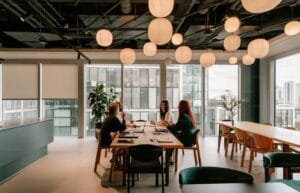 Three people at a table in a modern office